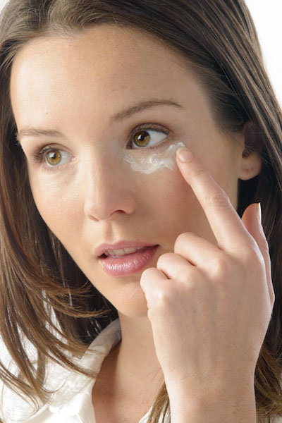 woman applying eye cream