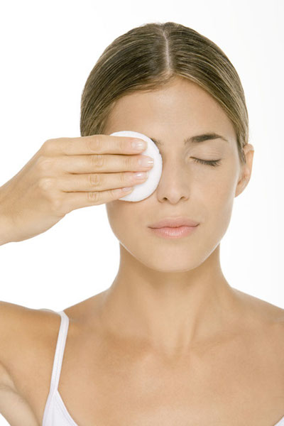 Woman removing eye make-up