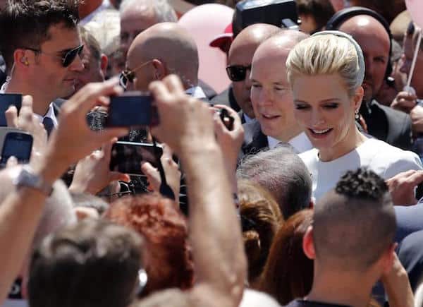 Prince Albert II of Monaco and his wife Princess Charlene are cheered by the crowd as they arrive at Monaco’s Palace after the christening ceremony of their twins