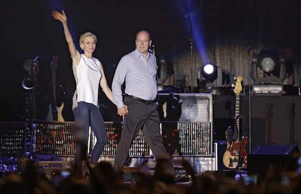 Prince Albert II of Monaco and Princess Charlene on stage to present Robbie Williams for a concert to celebrate the tenth anniversary of the reign of Albert II, in front of the Monaco Palace in Monaco, July 12, 2015.